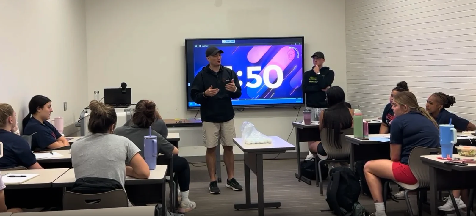 Trevor Conner leading a mental performance session with athletes in a classroom